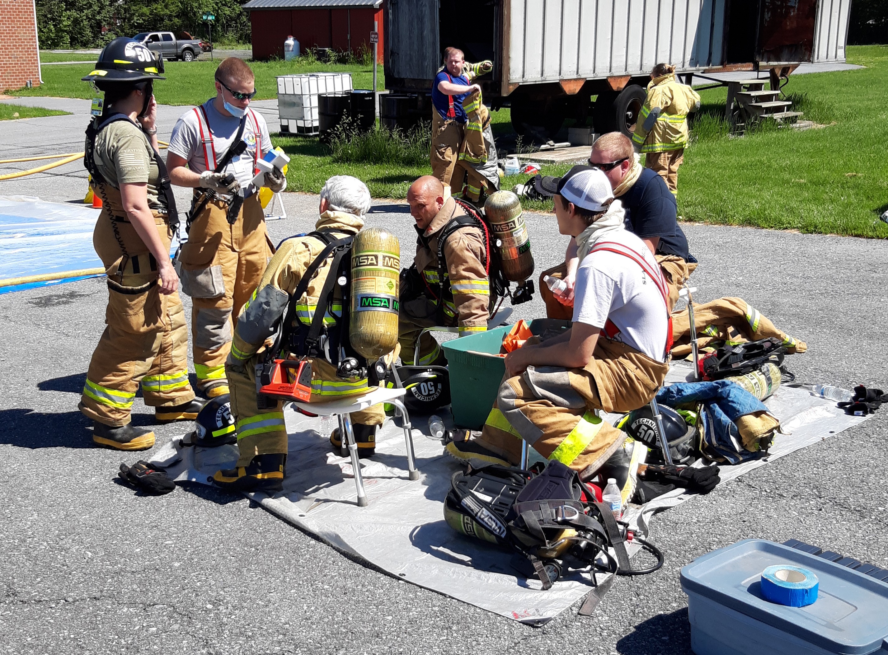Responders discussing a plan for meeting today's session with the Hazardous Material Training Prop.